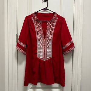 Red blouse with white stitching